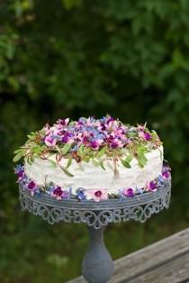 wedding photo - White wedding cake decorated with pink and purple petals